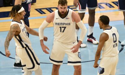 Memphis Grizzlies center Jonas Valanciunas (17) reacts with teammates Brandon Clarke (15) and De’Anthony Melton (0) after scoring in the second half of an NBA basketball game against the Washington Wizards Wednesday, March 10, 2021, in Memphis, Tenn. (AP Photo/Brandon Dill)
