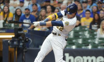 Christian Yelich swings during a home game for the Milwaukee Brewers.