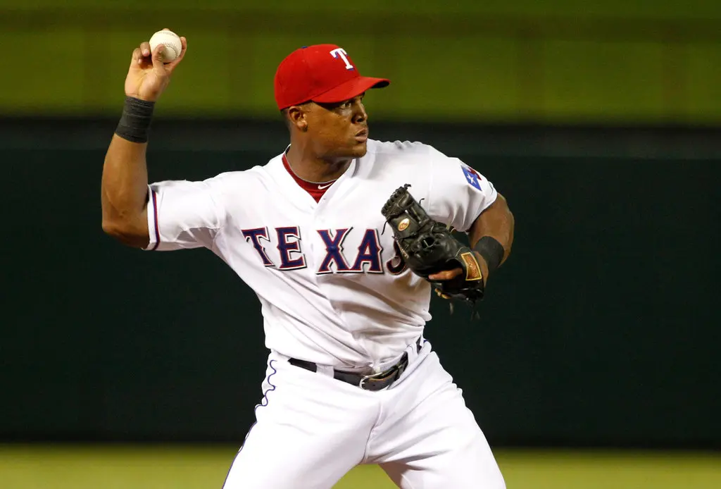 Adrian Beltre throws to first base while playing for the Texas Rangers.