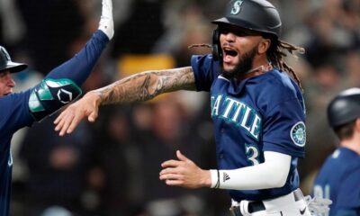 JP Crawford celebrates scoring a run for the Seattle Mariners.