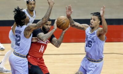 DJ Augustin drives into three Memphis defenders. AP Photo