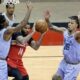 DJ Augustin drives into three Memphis defenders. AP Photo