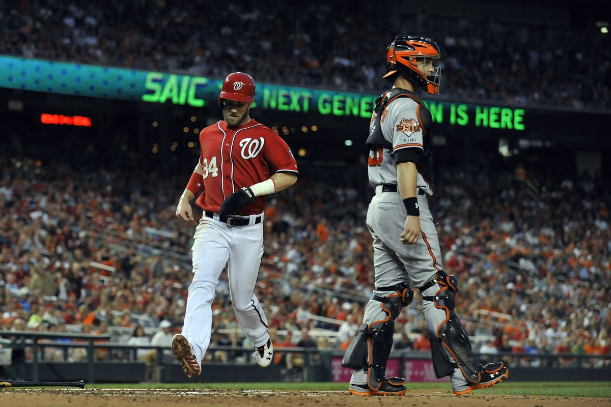 Bryce Harper scores for the Washington Nationals in a home game against the Baltimore Orioles.