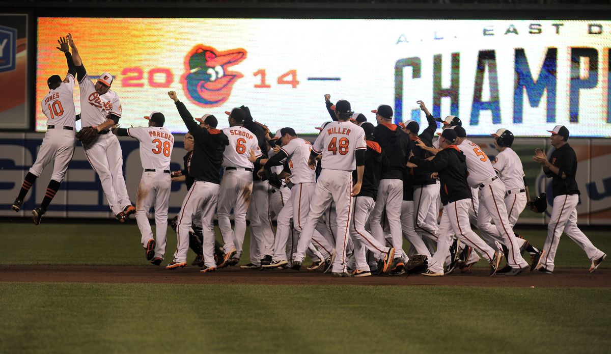 The Baltimore Orioles celebrate on the field after winning the AL East in 2014