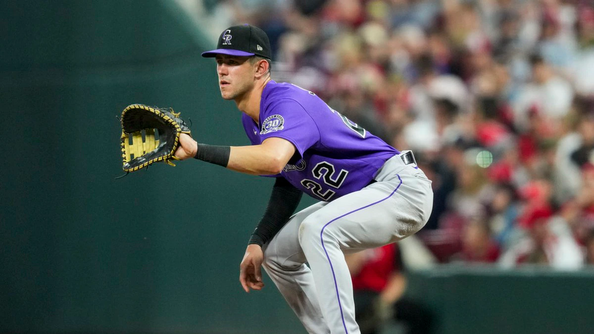 Nolan Jones waits to catch the ball at first base while playing for the Colorado Rockies against the Cincinnati Reds.