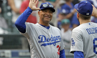 Los Angeles Dodgers Manager goes to high five Brian Dozier after a road win.