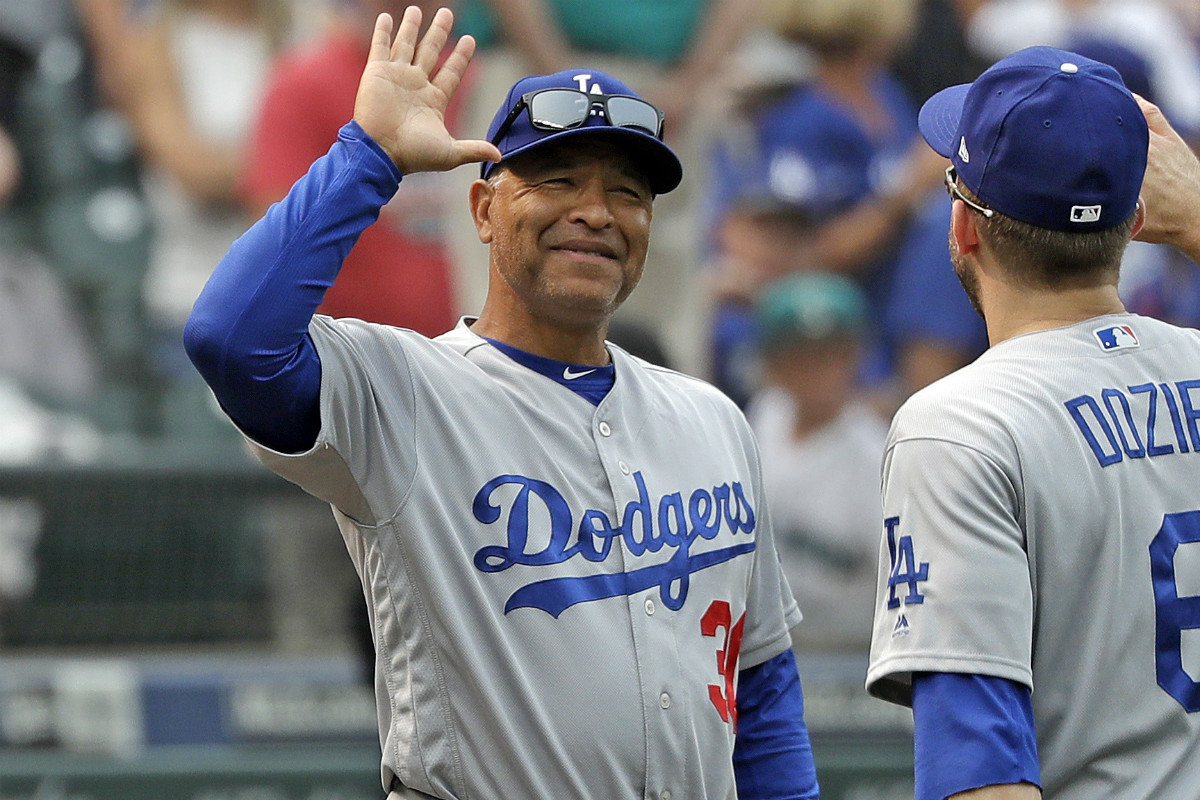 Los Angeles Dodgers Manager goes to high five Brian Dozier after a road win.