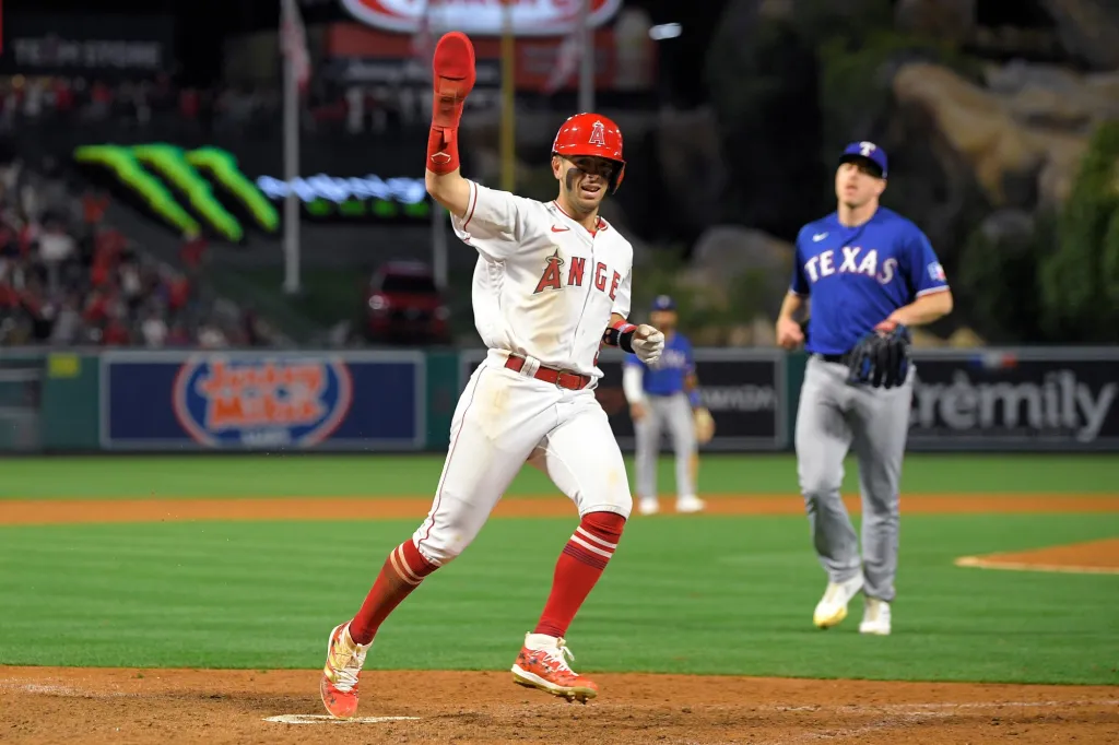 Zach Neto celebrates scoring the winning run for the Los Angeles Angels against the Texas Rangers.