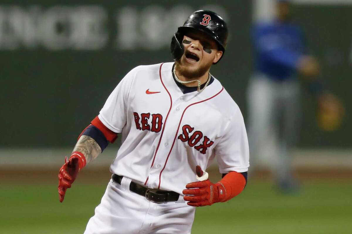 Alex Verdugo celebrates hitting a home run during a home game for the Boston Red Sox.
