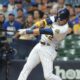 Christian Yelich swings during a home game for the Milwaukee Brewers.