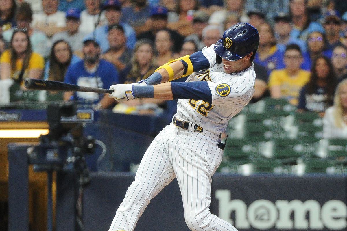 Christian Yelich swings during a home game for the Milwaukee Brewers.