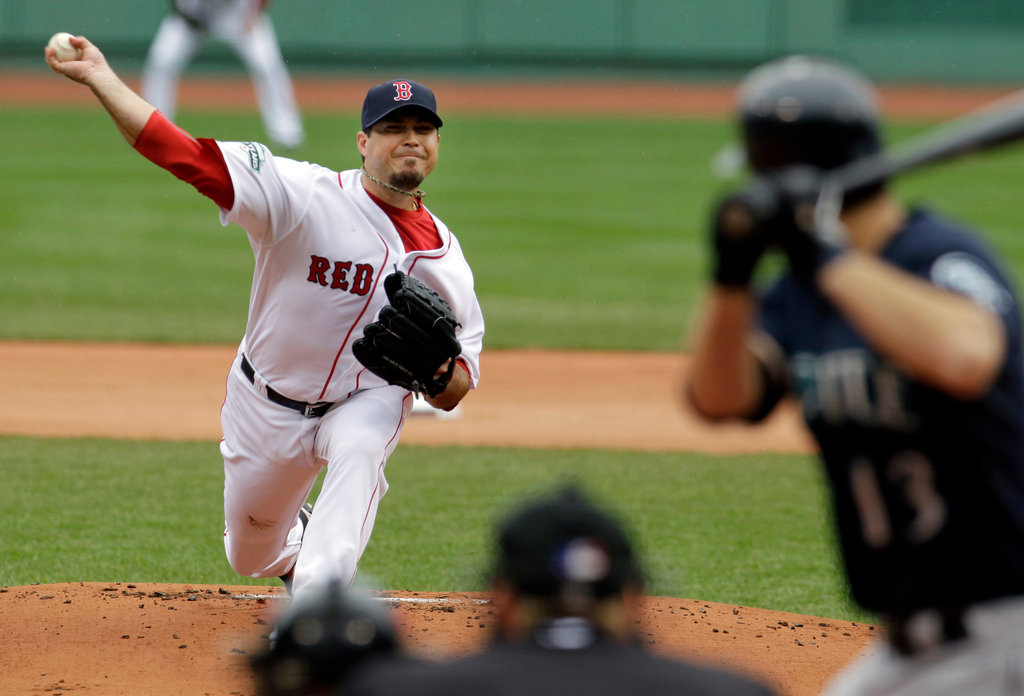 Josh Beckett pitches at home for the Boston Red Sox against the Seattle Mariners.