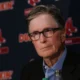 John Henry listens to a question during a press conference.