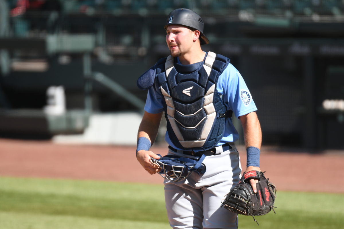 Cal Raleigh surveys the field while playing in a scrimmage for the Seattle Mariners.