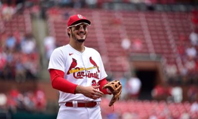Nolan Arenado smiles toward the dugout while playing defense for the St. Louis Cardinals.