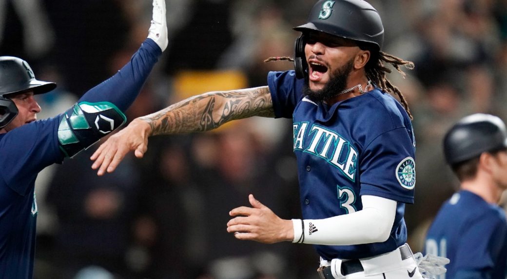 JP Crawford celebrates scoring a run for the Seattle Mariners.