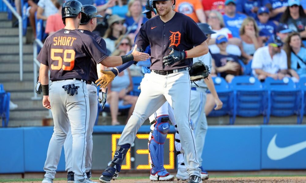 Parker Meadows high fives his teammates on the Detroit Tigers.