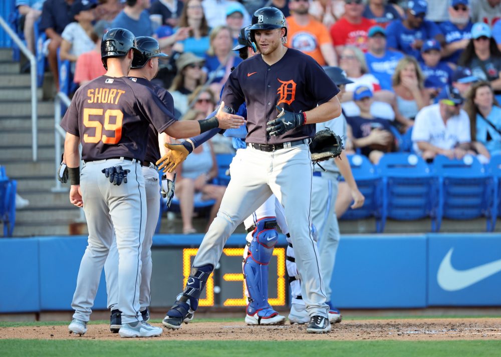 Parker Meadows high fives his teammates on the Detroit Tigers.