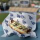 A hotdog sold at Dodger Stadium lies on a section ledge.