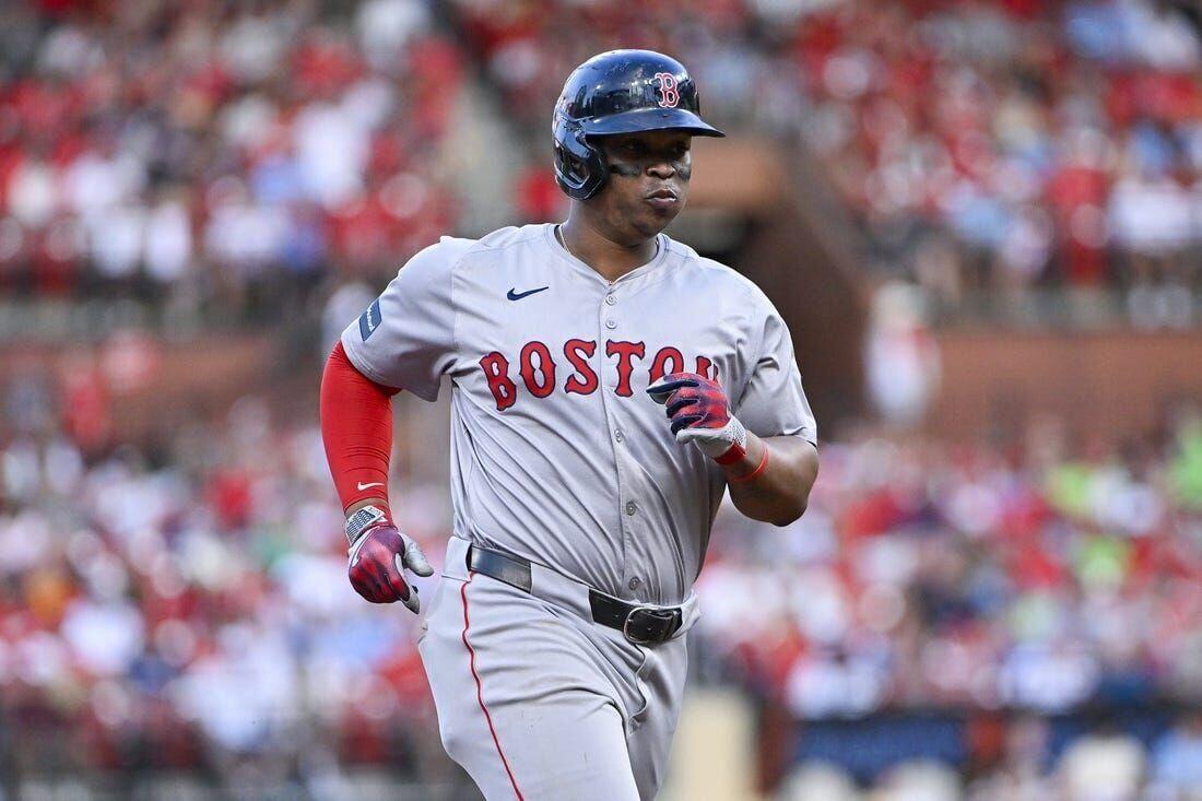 Rafael Devers jogs around the bases after hitting a home run against the St. Louis Cardinals.