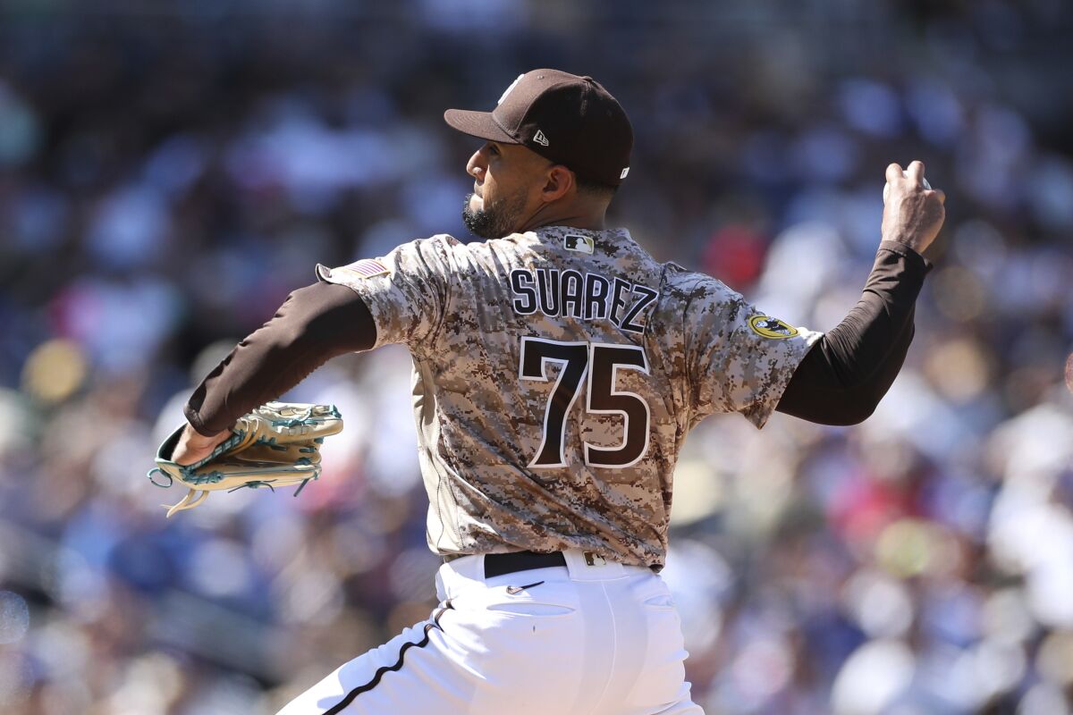 Robert Suarez pitches at home for the San Diego Padres.