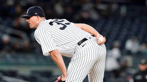Clay Holmes leans in for the sign from his catcher.
