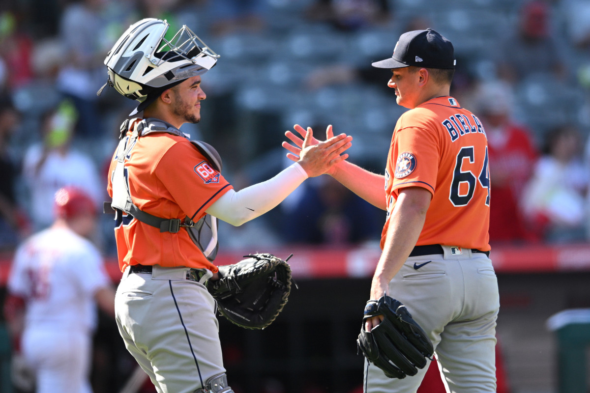 Yainer Diaz and Brandon Bielak high five after a Houston Astros win.