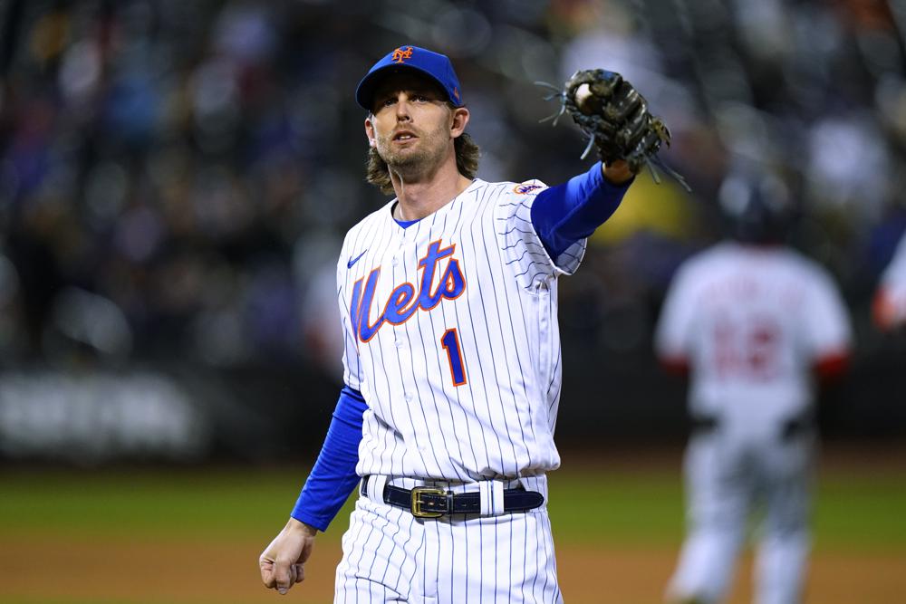 Jee McNeil gesture to the crowd during a New York Mets home game.