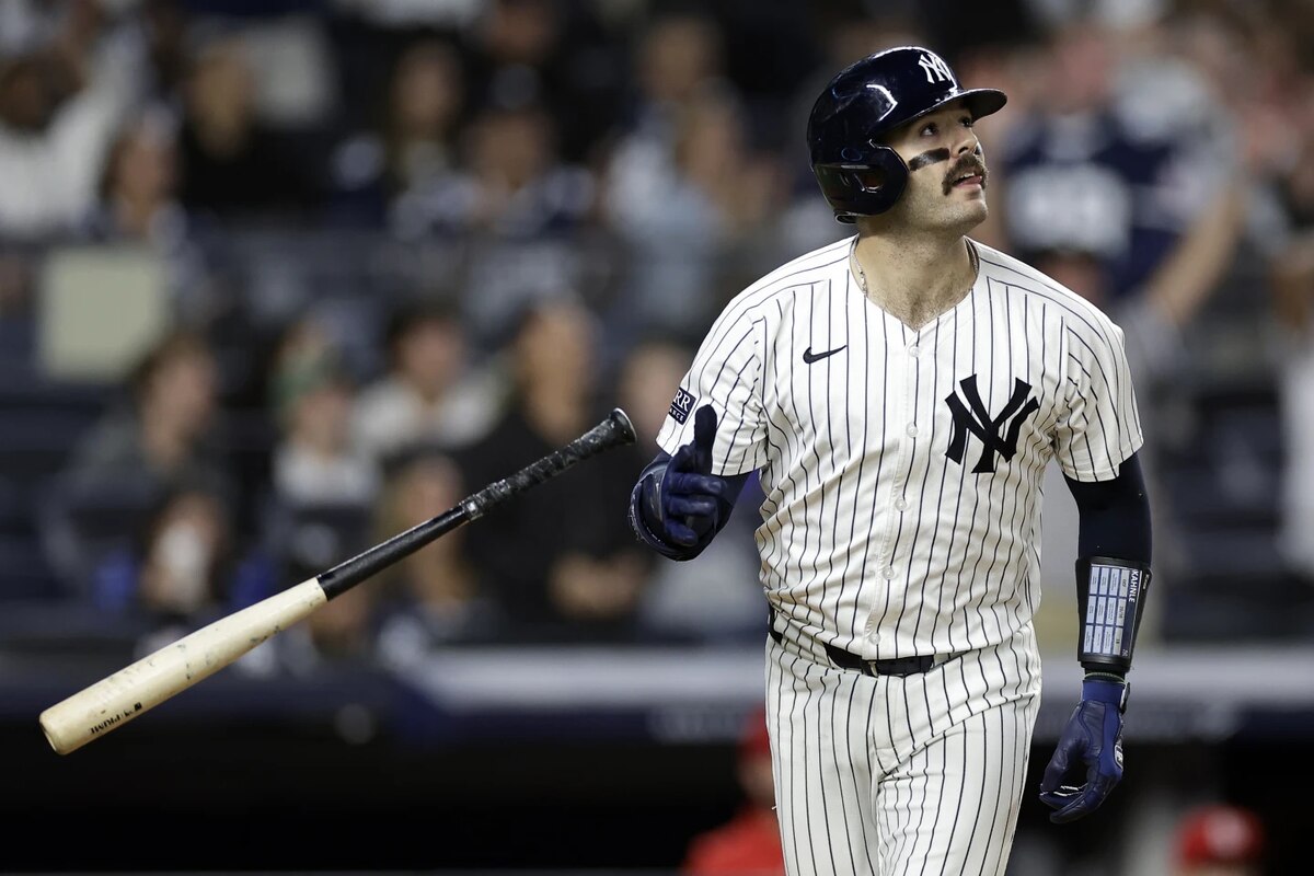 Austin Wells flips his bat after hitting a home run at home for the New York Yankees.
