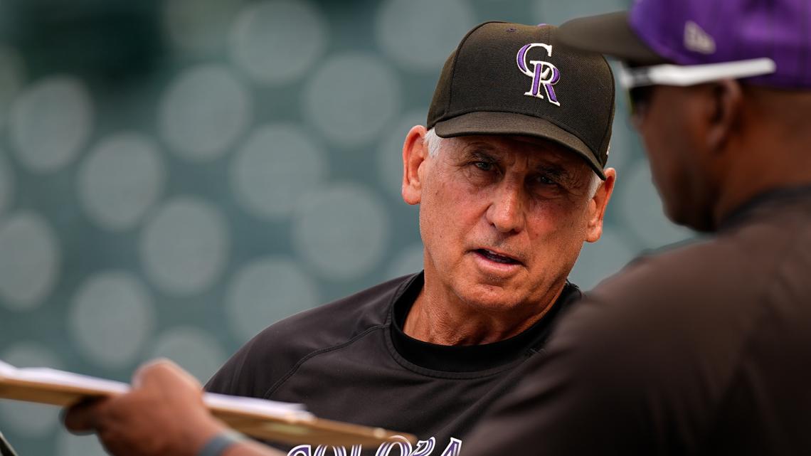 Bud Black speaks to a coach before a Colorado Rockies game.