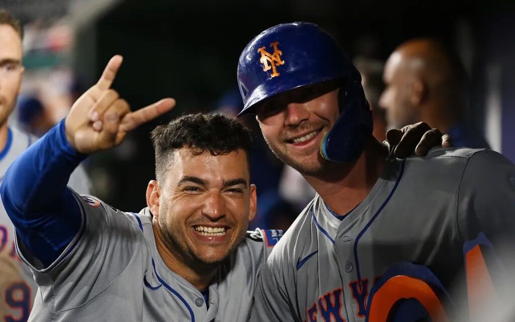 Jose Iglesias and Pete Alonso celebrate in the New York Mets dugout.