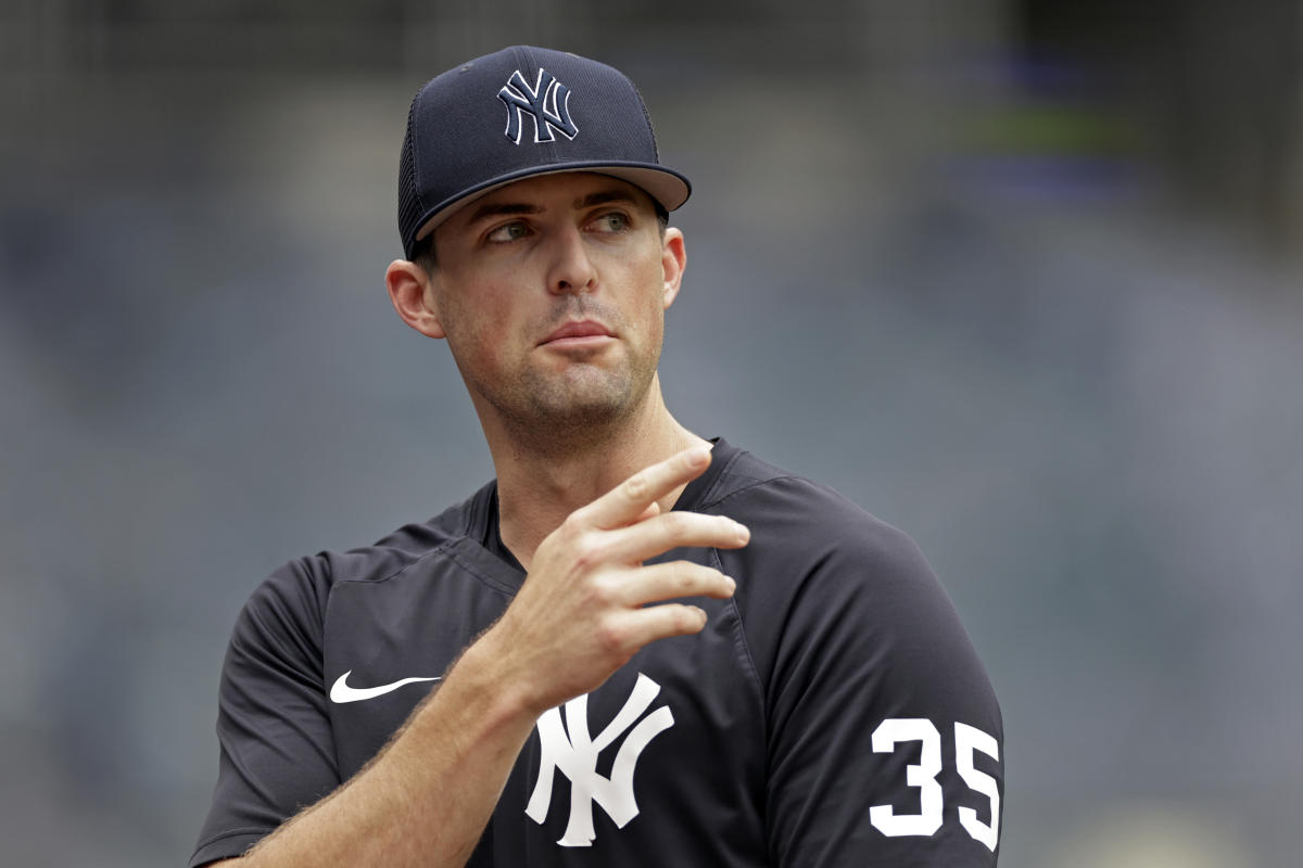 Clay Holmes speaks to a reporter before a game for the New York Yankees.