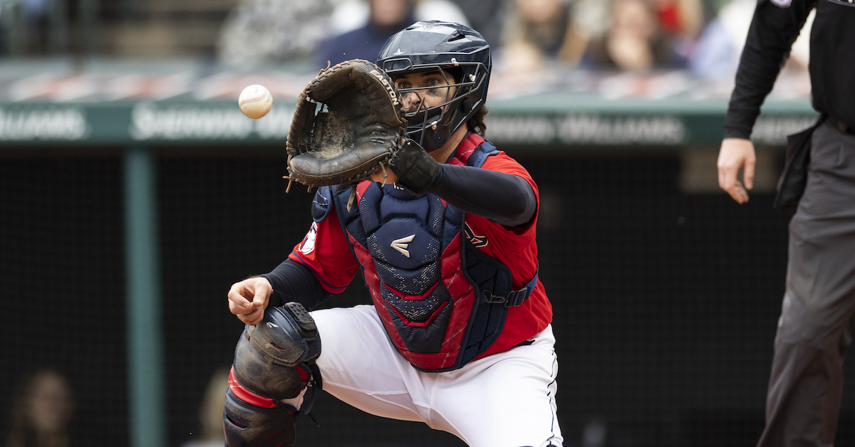 Austin Hedges prepares to catch the ball at home plate while playing for the Cleveland Guardians.