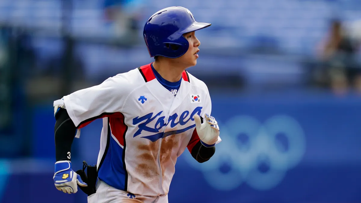 Hyeseong Kim runs to first base while playing for South Korea.