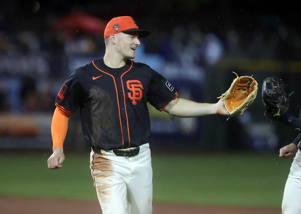 Matt Chapman celebrates with a teammate on the San Francisco Giants.