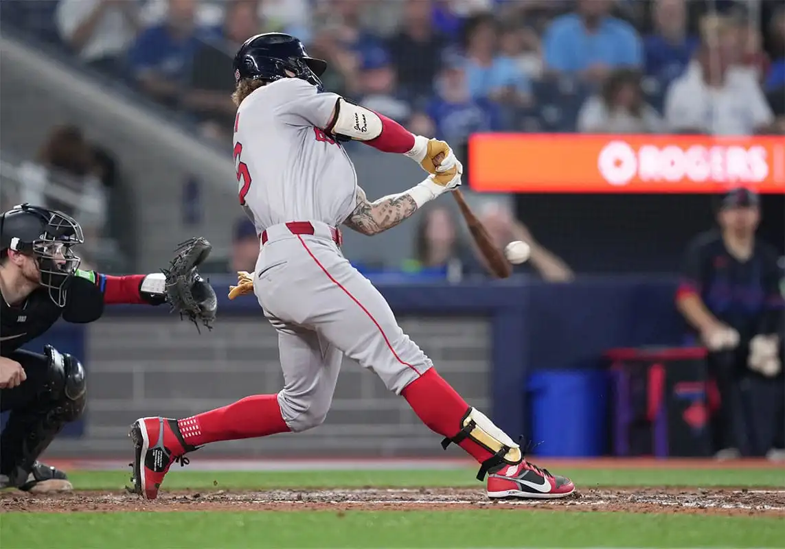 Jarren Duran makes contact at the plate while playing for the Boston Red Sox against the Toronto Blue Jays.