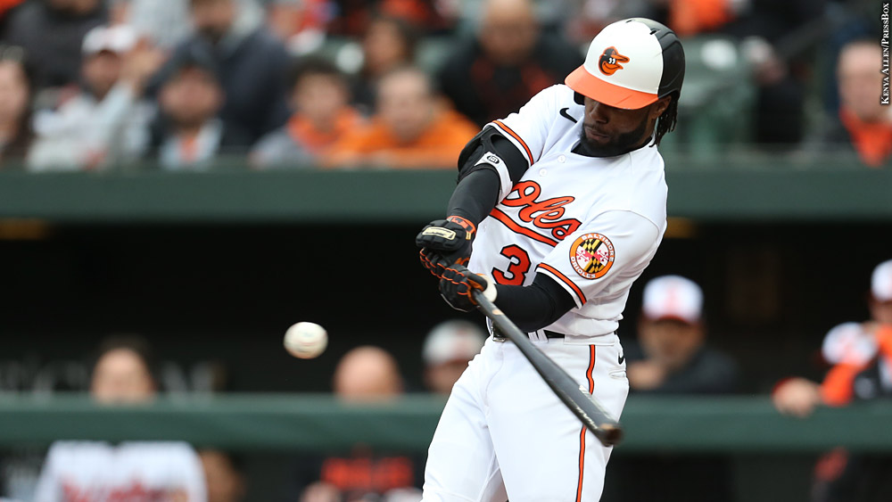 Cedric Mullins swings while playing at home for the Baltimore Orioles.