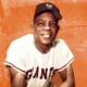 Willie Mays takes a knee while playing for the San Francisco Giants.