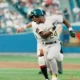 Rickey Henderson evades a tag while playing for the Oakland A's.