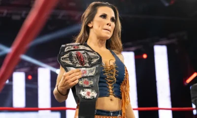 Mickie James is in the ring with a championship.
